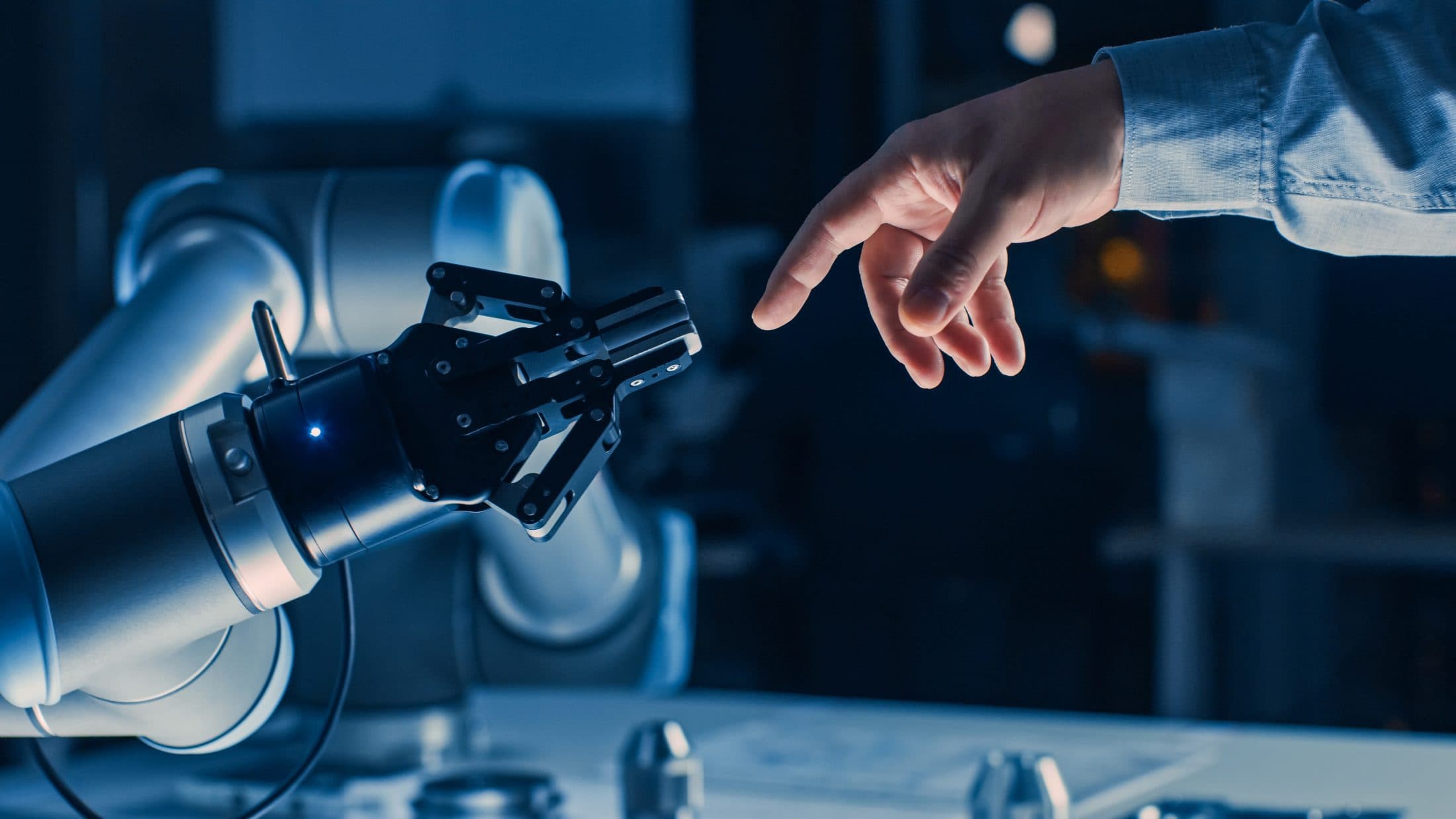 Human and robotic hands reaching toward each other